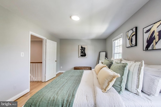 bedroom with baseboards and light wood-style flooring