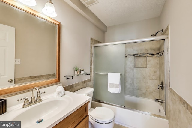 bathroom with vanity, visible vents, toilet, and tile walls