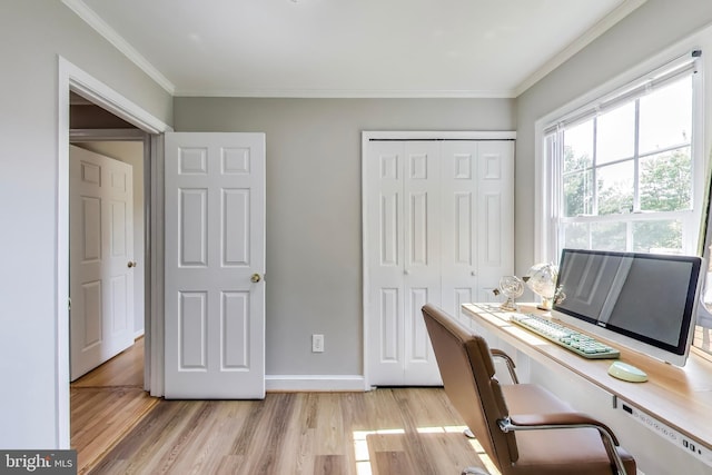 office space featuring baseboards, ornamental molding, and light wood finished floors