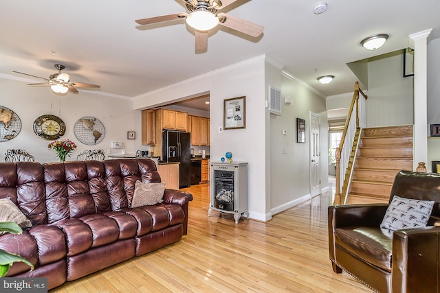 107 Washington Square Ct, Occoquan, VA 22125 - living room featuring ornamental molding, baseboards, stairway, a ceiling fan, and light wood finished floors
