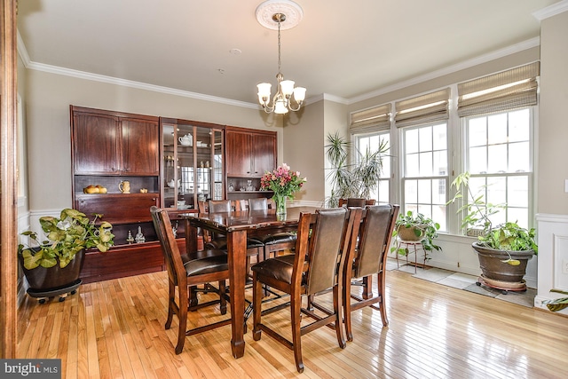 107 Washington Square Ct, Occoquan, VA 22125 - dining space with a decorative wall, a chandelier, a wainscoted wall, light wood-type flooring, and ornamental molding