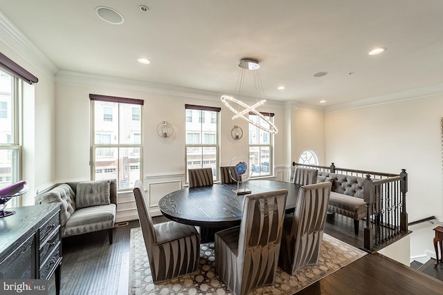 dining space with a wainscoted wall, an inviting chandelier, recessed lighting, ornamental molding, and dark wood finished floors