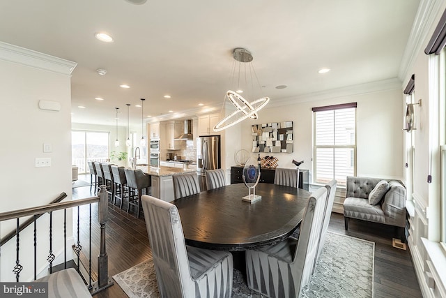 dining space featuring a chandelier, crown molding, dark wood-style floors, and recessed lighting