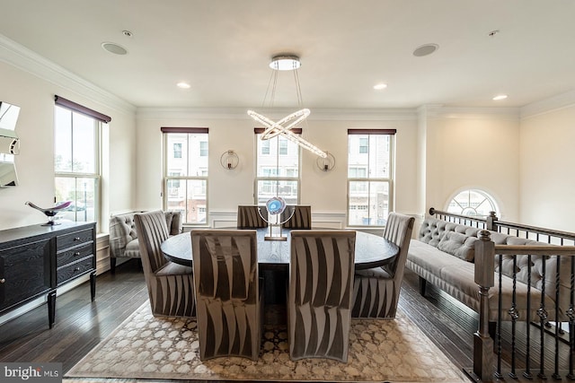 dining room with dark wood-style flooring, a wainscoted wall, ornamental molding, and recessed lighting