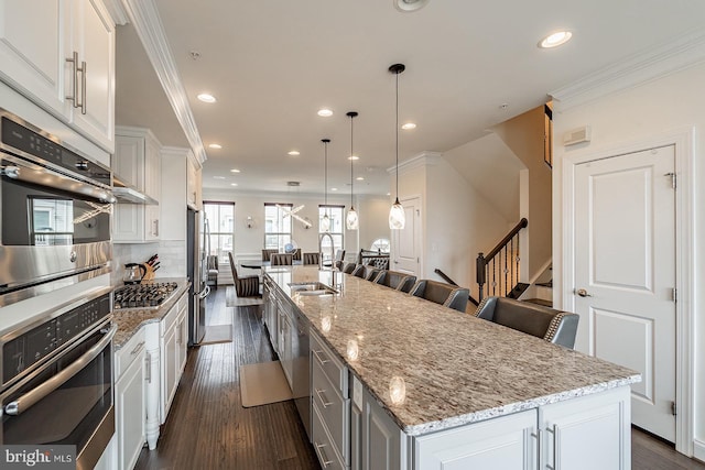 kitchen featuring stainless steel appliances, recessed lighting, and a sink