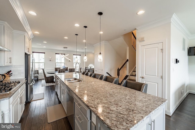 kitchen with recessed lighting, a spacious island, appliances with stainless steel finishes, a sink, and white cabinetry