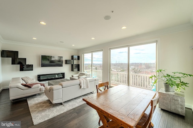 living area with baseboards, recessed lighting, ornamental molding, and wood finished floors
