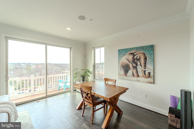 dining room with visible vents, crown molding, dark wood-style floors, and baseboards