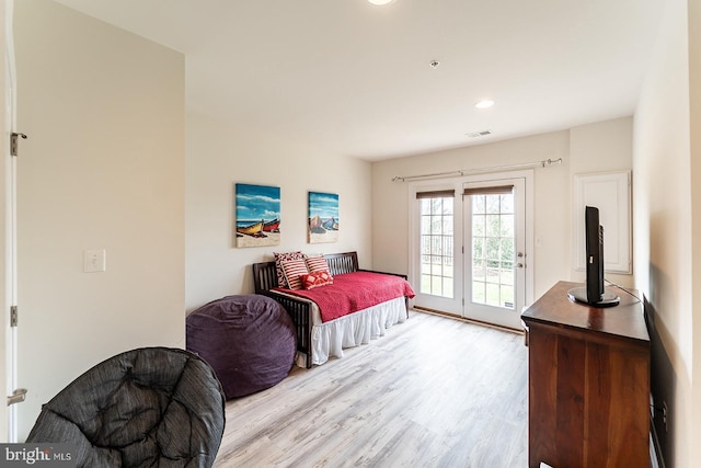 bedroom with wood finished floors, recessed lighting, visible vents, and access to exterior