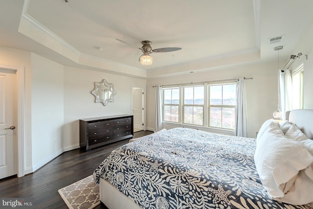 bedroom with visible vents, multiple windows, and a tray ceiling