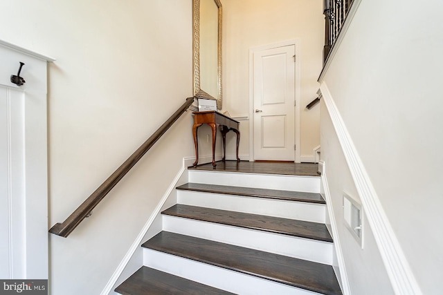 staircase featuring a high ceiling