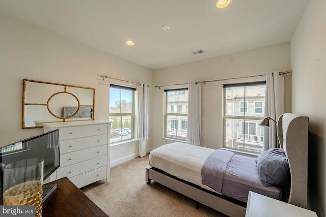 bedroom with baseboards, recessed lighting, visible vents, and light carpet