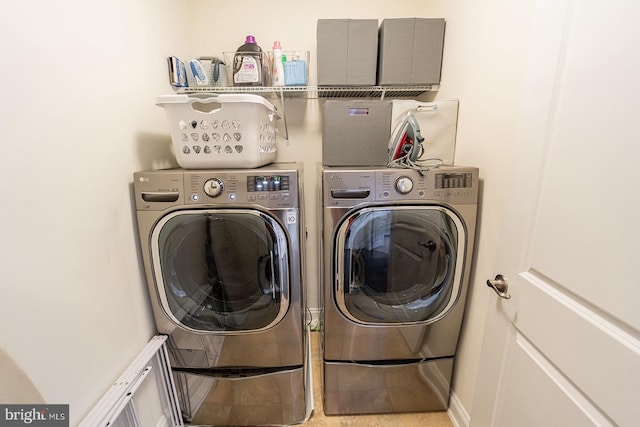 clothes washing area with separate washer and dryer and laundry area