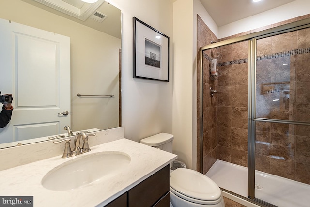 bathroom with toilet, visible vents, a shower stall, and vanity