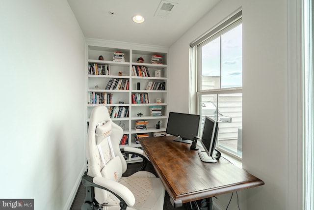 office area with visible vents, built in features, and baseboards