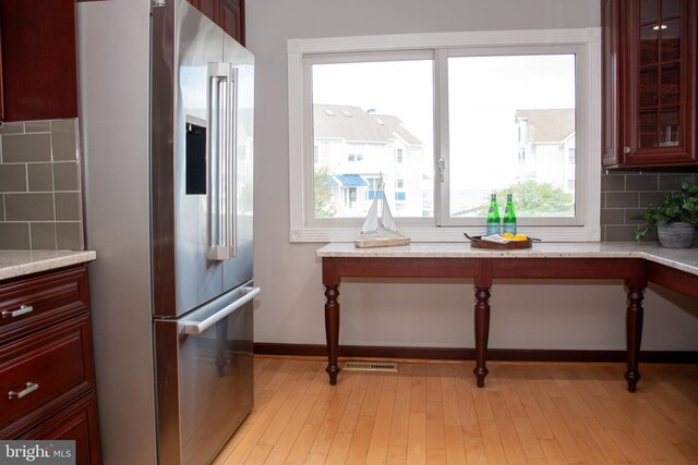 8074 Windward Key Dr, Chesapeake Beach, MD 20732 - kitchen with high quality fridge, reddish brown cabinets, backsplash, and light wood finished floors