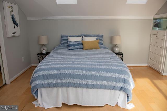 8074 Windward Key Dr, Chesapeake Beach, MD 20732 - bedroom with a skylight, light wood-style flooring, baseboards, and ornamental molding