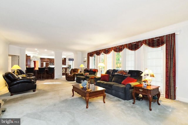 living room featuring ornamental molding, decorative columns, light colored carpet, and baseboards