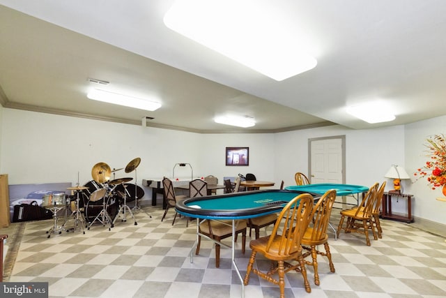 playroom with light floors, visible vents, and crown molding