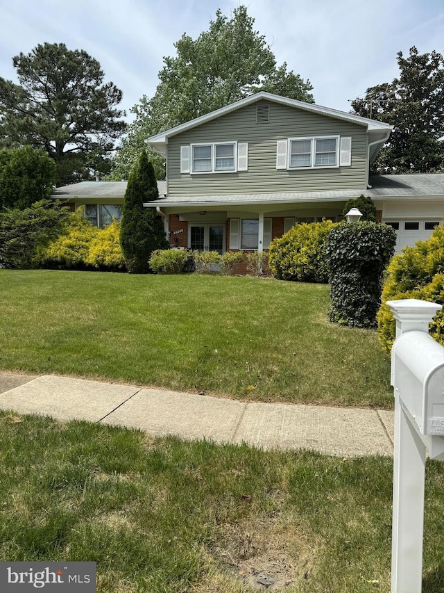 traditional-style home featuring a front lawn