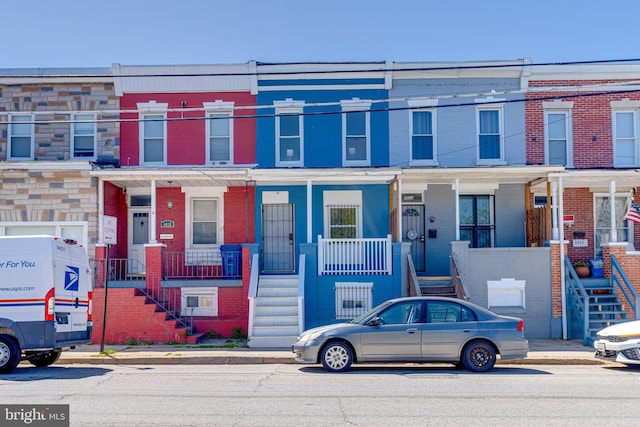 4026 Pennington Ave, Baltimore City, MD 21226 - townhome / multi-family property with stairs, covered porch, and brick siding
