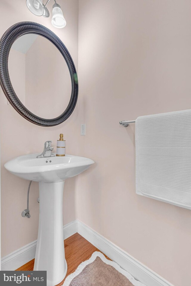 bathroom featuring baseboards and wood finished floors