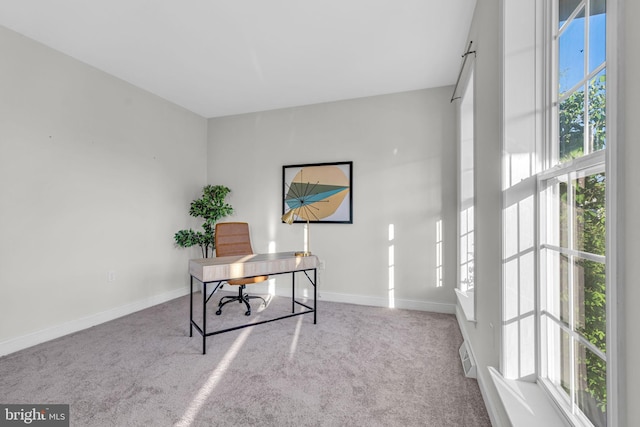 carpeted office space with baseboards and visible vents