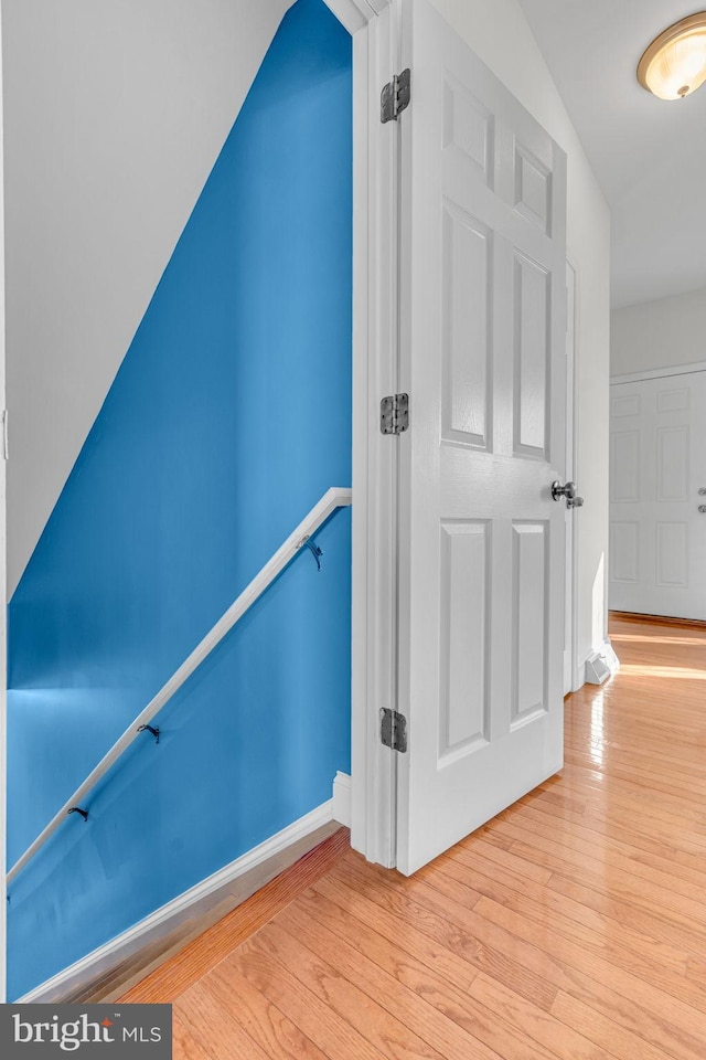 stairway featuring wood-type flooring and baseboards