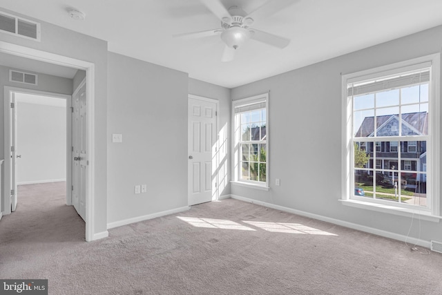 unfurnished bedroom featuring carpet flooring, baseboards, visible vents, and a closet