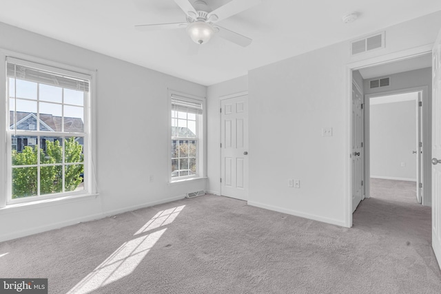 unfurnished bedroom featuring visible vents, carpet, and baseboards