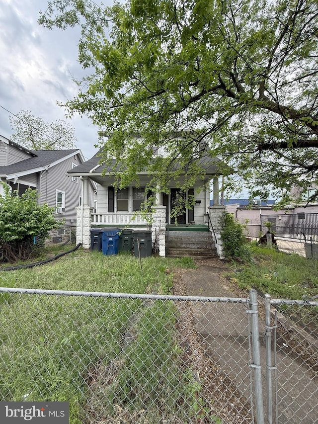back of house with a fenced front yard