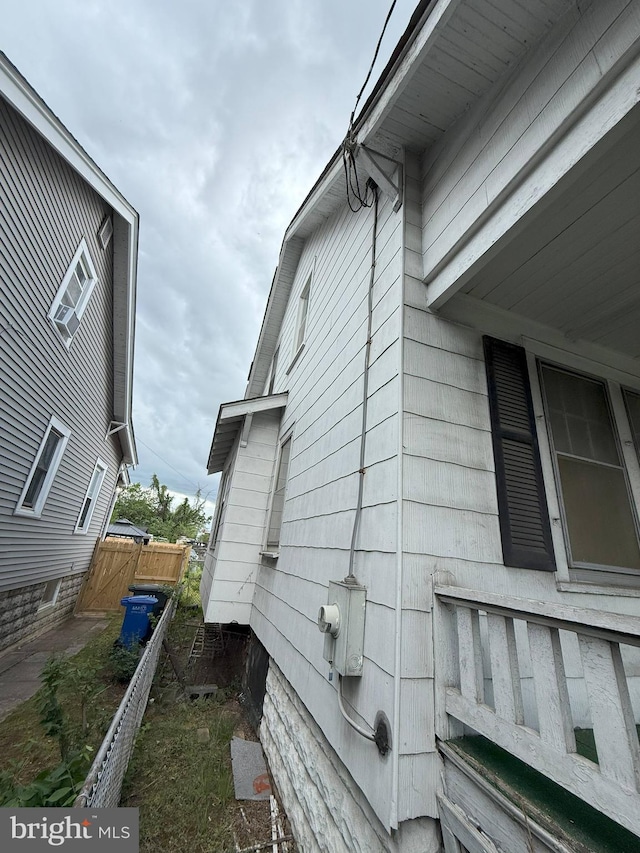 view of side of property featuring central AC unit and fence
