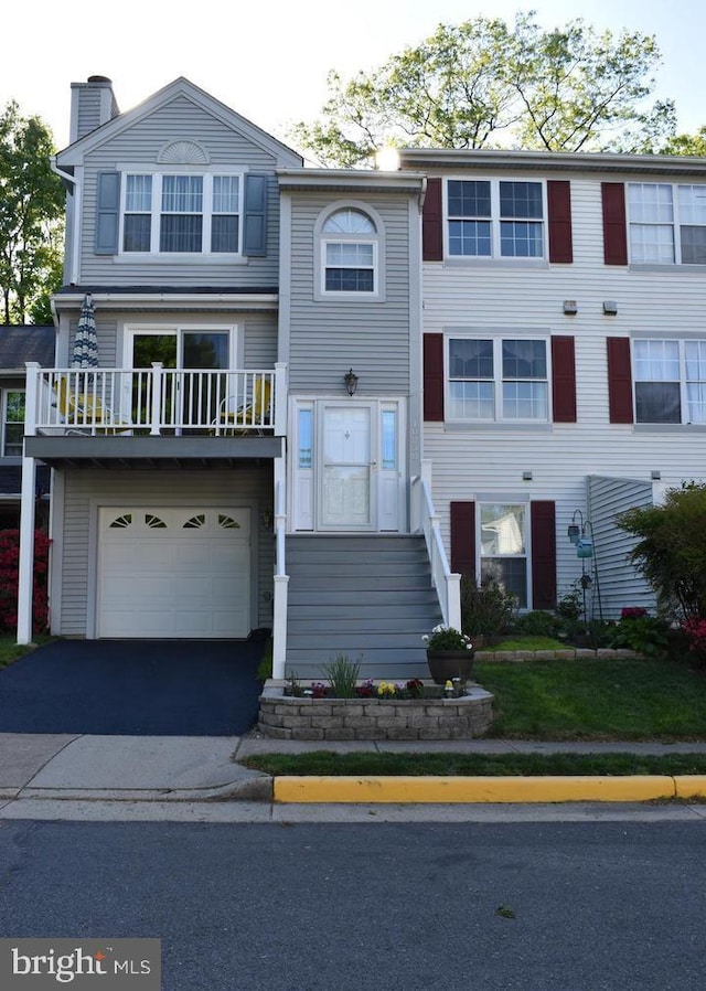 10230 Faire Commons Ct, Burke, VA 22015 - view of front of property with an attached garage, a chimney, a balcony, and aphalt driveway
