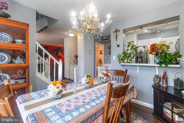 10230 Faire Commons Ct, Burke, VA 22015 - dining area featuring baseboards, wood finished floors, a chandelier, and stairway