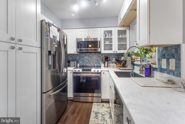 10230 Faire Commons Ct, Burke, VA 22015 - kitchen featuring light countertops, appliances with stainless steel finishes, white cabinets, and dark wood-style floors