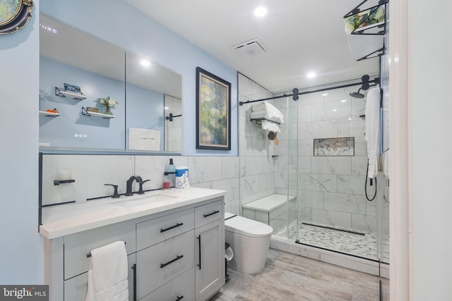 10230 Faire Commons Ct, Burke, VA 22015 - full bathroom with vanity, toilet, recessed lighting, tile walls, and a stall shower