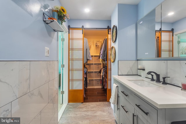 10230 Faire Commons Ct, Burke, VA 22015 - full bathroom with vanity, a walk in closet, and wood finished floors