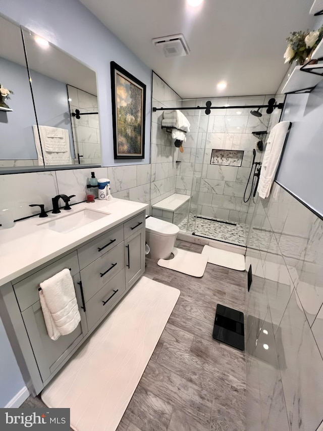 10230 Faire Commons Ct, Burke, VA 22015 - bathroom featuring vanity, a shower stall, toilet, and tile walls