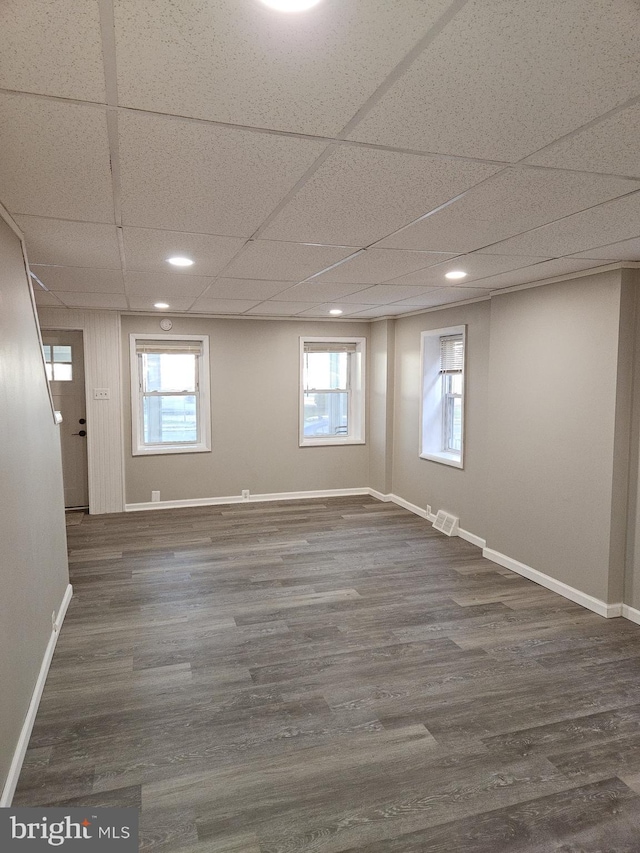 4216 Post Rd, Trainer, PA 19061 - below grade area with visible vents, dark wood-style floors, a drop ceiling, and baseboards
