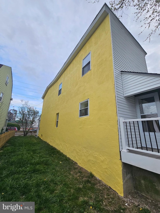 4216 Post Rd, Trainer, PA 19061 - view of side of property with a yard, stucco siding, and fence