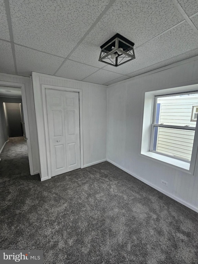 4216 Post Rd, Trainer, PA 19061 - unfurnished bedroom featuring baseboards, dark carpet, a closet, and a paneled ceiling