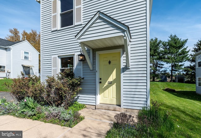 doorway to property featuring a yard