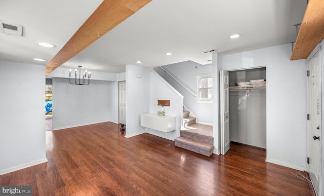 interior space featuring visible vents, stairway, wood finished floors, and baseboards