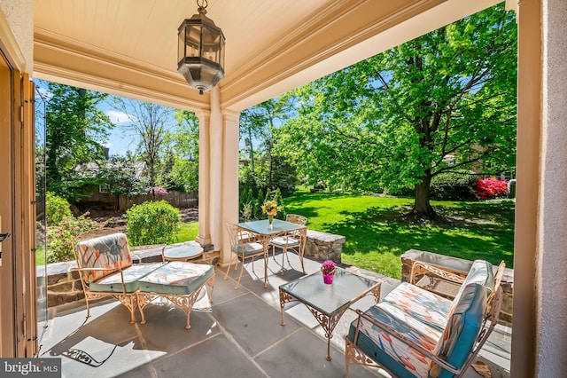 view of patio with an outdoor living space and fence
