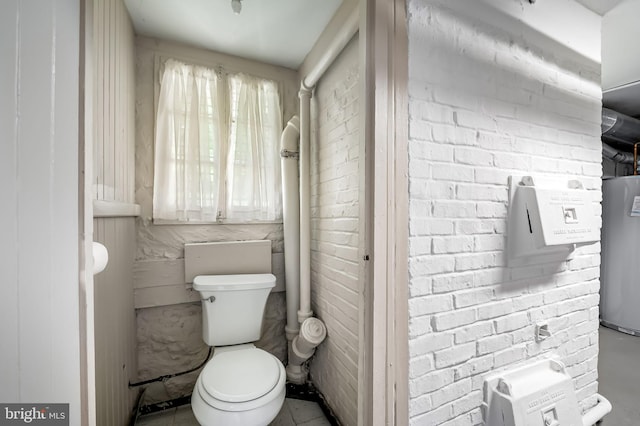bathroom featuring water heater and toilet