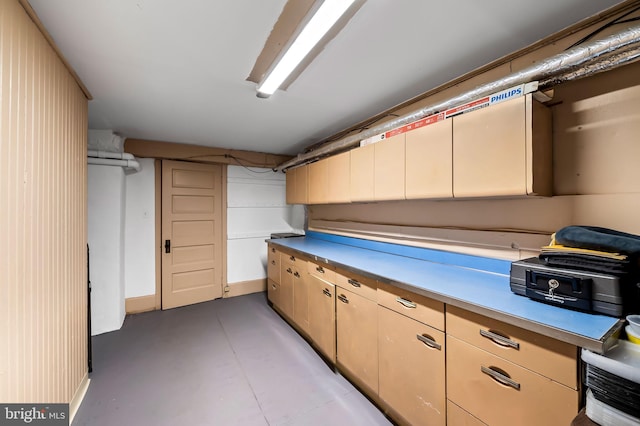 interior space with light countertops and concrete floors