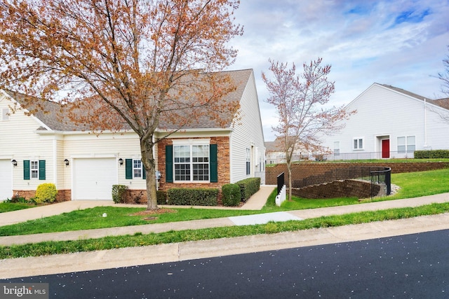 view of front of home with a garage, concrete driveway, a front lawn, and stone siding