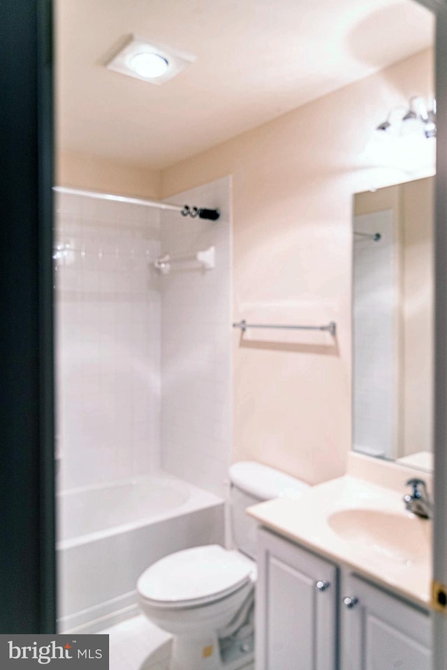 bathroom featuring toilet, vanity, and  shower combination