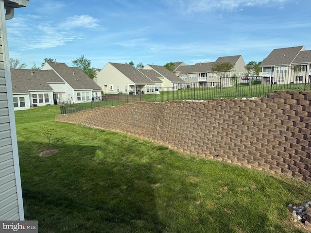 view of yard with fence and a residential view