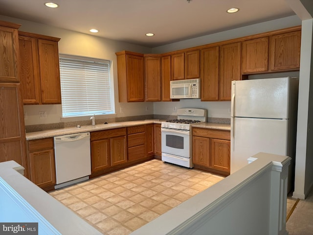kitchen with recessed lighting, brown cabinets, and white appliances